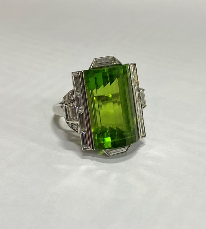 Late Art Deco fancy peridot and diamond dress ring, c.1940, the rectangular peridot arch-topped and step line facetted, | MasterArt